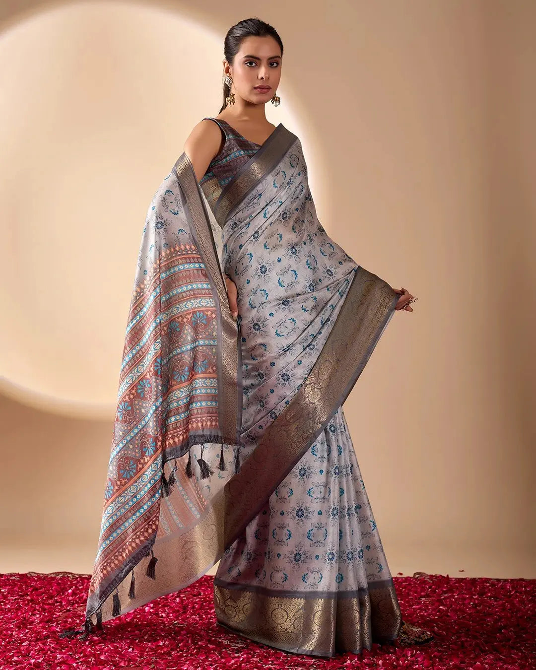 Woman wearing a patterned saree on a beige background